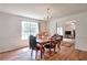 Elegant dining room featuring a decorative chandelier, a large window, and hardwood floors at 1282 Berryhill Dr, Lithonia, GA 30058