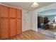 Spacious entryway with wood flooring, tall pantry cabinets and a view of the living room at 1282 Berryhill Dr, Lithonia, GA 30058