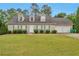 Charming one-story home featuring a well-manicured lawn, dormer windows and a two-car attached garage at 1282 Berryhill Dr, Lithonia, GA 30058