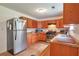 Functional kitchen featuring wood cabinets, stone countertops, and stainless steel appliances at 1282 Berryhill Dr, Lithonia, GA 30058