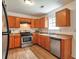 Practical kitchen featuring modern appliances, light wood cabinetry, and stone countertops at 1282 Berryhill Dr, Lithonia, GA 30058