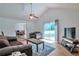 Bright living room with a ceiling fan, access to the backyard, and wood floors at 1282 Berryhill Dr, Lithonia, GA 30058