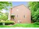 Spacious backyard with lush lawn and partial brick exterior, offering a private outdoor space at 1996 Cobblestone Ne Cir, Atlanta, GA 30319