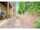 View of private backyard with mature trees and a stone paver path at 1996 Cobblestone Ne Cir, Atlanta, GA 30319