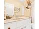 Bright bathroom featuring a granite countertop, white cabinets, and decorative shelving, offering a clean and inviting space at 1996 Cobblestone Ne Cir, Atlanta, GA 30319