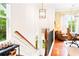 Upstairs hallway leading to home office with hardwood floors and wood railing at 1996 Cobblestone Ne Cir, Atlanta, GA 30319
