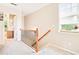 Bright hallway features plush carpet and a wooden railing staircase leading to other rooms at 1996 Cobblestone Ne Cir, Atlanta, GA 30319