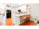 Well-lit kitchen with white cabinets, marble countertops, a modern backsplash, and seating for casual dining at 1996 Cobblestone Ne Cir, Atlanta, GA 30319