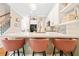 Close-up view of kitchen island with marble countertop, trendy stools, and stainless steel appliances at 1996 Cobblestone Ne Cir, Atlanta, GA 30319