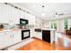 Bright kitchen with white cabinets, stainless steel appliances, and a decorative backsplash at 1996 Cobblestone Ne Cir, Atlanta, GA 30319