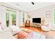 Bright living room with a large TV, comfy armchair, and stylish decor, perfect for relaxing and entertaining at 1996 Cobblestone Ne Cir, Atlanta, GA 30319