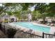 Community pool surrounded by lounge chairs and mature trees at 1996 Cobblestone Ne Cir, Atlanta, GA 30319