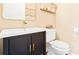 Stylish powder room with dark vanity, gold hardware, and modern decor at 1996 Cobblestone Ne Cir, Atlanta, GA 30319
