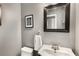 Traditional powder room featuring a pedestal sink, framed mirror, and bicycle art at 2486 Memorial Se Dr, Atlanta, GA 30317