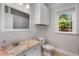 Updated bathroom with a granite countertop, white cabinets, and natural light at 2486 Memorial Se Dr, Atlanta, GA 30317