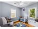Cozy Bedroom with hardwood floors, two windows, rocking chair, and crib at 2486 Memorial Se Dr, Atlanta, GA 30317