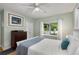 This spacious bedroom features hardwood floors, a ceiling fan, and white curtains at 2486 Memorial Se Dr, Atlanta, GA 30317