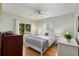 A bright bedroom with a large window, white trim, hardwood floors and ceiling fan at 2486 Memorial Se Dr, Atlanta, GA 30317