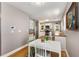 Cozy dining area featuring a white table, wood floors, and plenty of natural light next to the kitchen at 2486 Memorial Se Dr, Atlanta, GA 30317
