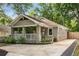 Charming exterior with brick facade, covered porch, and lush landscaping at 2486 Memorial Se Dr, Atlanta, GA 30317