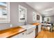 A bright kitchen showcasing a white farmhouse sink, wooden countertops, and white cabinets at 2486 Memorial Se Dr, Atlanta, GA 30317