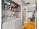 Convenient laundry area with washer, dryer, and storage shelves with easy access to the hall at 2486 Memorial Se Dr, Atlanta, GA 30317
