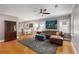 Spacious living room with hardwood floors, ample natural light, and stylish furnishings adjacent to the kitchen at 2486 Memorial Se Dr, Atlanta, GA 30317