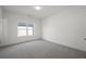 Bedroom with neutral carpet, a ceiling light, and a window that offer views of the neighborhood at 6660 Wallace Farms Dr, Cumming, GA 30028
