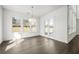 Bright dining room with wood floors, many windows, and view to the fenced backyard at 6660 Wallace Farms Dr, Cumming, GA 30028