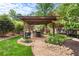 Beautiful backyard with a covered patio, landscaping, and seating area at 209 Hearthstone Reach, Peachtree City, GA 30269