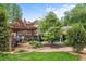 Manicured lawn featuring a covered patio with dining area and mature trees at 209 Hearthstone Reach, Peachtree City, GA 30269