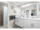 Bright bathroom featuring double vanity, white cabinets, walk-in shower, and neutral tile floors at 209 Hearthstone Reach, Peachtree City, GA 30269