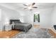 Bedroom with light gray walls, hardwood floors, a gray rug and a window at 209 Hearthstone Reach, Peachtree City, GA 30269