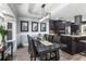 Formal dining room featuring dark wood table with seating for eight, modern lighting, and view to kitchen at 209 Hearthstone Reach, Peachtree City, GA 30269