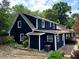 Rear exterior view of home featuring a well-maintained blue exterior with an established landscape design at 209 Hearthstone Reach, Peachtree City, GA 30269