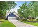 Beautiful home with a two-car garage, well-maintained lawn, and a driveway leading to a picturesque entrance at 209 Hearthstone Reach, Peachtree City, GA 30269