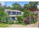 Home exterior showcasing landscaping, trees, and backyard patio area at 209 Hearthstone Reach, Peachtree City, GA 30269
