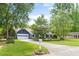 Lovely home with lush green lawn, a well-kept yard, and a driveway leading to an attached garage, showing curb appeal at 209 Hearthstone Reach, Peachtree City, GA 30269