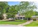 Inviting home showcasing a landscaped yard, well-manicured lawn, and an attached garage, exuding curb appeal at 209 Hearthstone Reach, Peachtree City, GA 30269