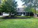 Charming home featuring a well-manicured front yard, attached garage, and inviting front porch at 209 Hearthstone Reach, Peachtree City, GA 30269