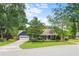 Charming two-story home with lush green lawn, mature trees, and a driveway leading to an attached garage at 209 Hearthstone Reach, Peachtree City, GA 30269
