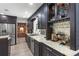 Gourmet kitchen with granite countertops, stainless appliances, and a wine rack at 209 Hearthstone Reach, Peachtree City, GA 30269