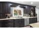 Elegant kitchen featuring granite countertops, stainless appliances, and a view to the backyard at 209 Hearthstone Reach, Peachtree City, GA 30269