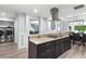 Open kitchen with granite countertops, stainless appliances, and breakfast bar seating at 209 Hearthstone Reach, Peachtree City, GA 30269