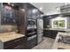 Modern kitchen with stainless steel appliances, granite countertops, and glass front cabinetry at 209 Hearthstone Reach, Peachtree City, GA 30269
