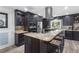 Spacious kitchen with granite countertops, stainless appliances, an island, and bar stools at 209 Hearthstone Reach, Peachtree City, GA 30269