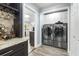 Convenient laundry room with modern washer and dryer, adjacent to the kitchen at 209 Hearthstone Reach, Peachtree City, GA 30269