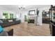 Bright living room with a stone fireplace, wood flooring, and a comfortable couch, creating a cozy atmosphere at 209 Hearthstone Reach, Peachtree City, GA 30269