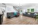 Bright living room with hardwood floors and comfortable couches for relaxing and entertaining at 209 Hearthstone Reach, Peachtree City, GA 30269