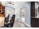 Bright home office featuring custom built-ins, workstation for two, and large window and exterior access at 209 Hearthstone Reach, Peachtree City, GA 30269